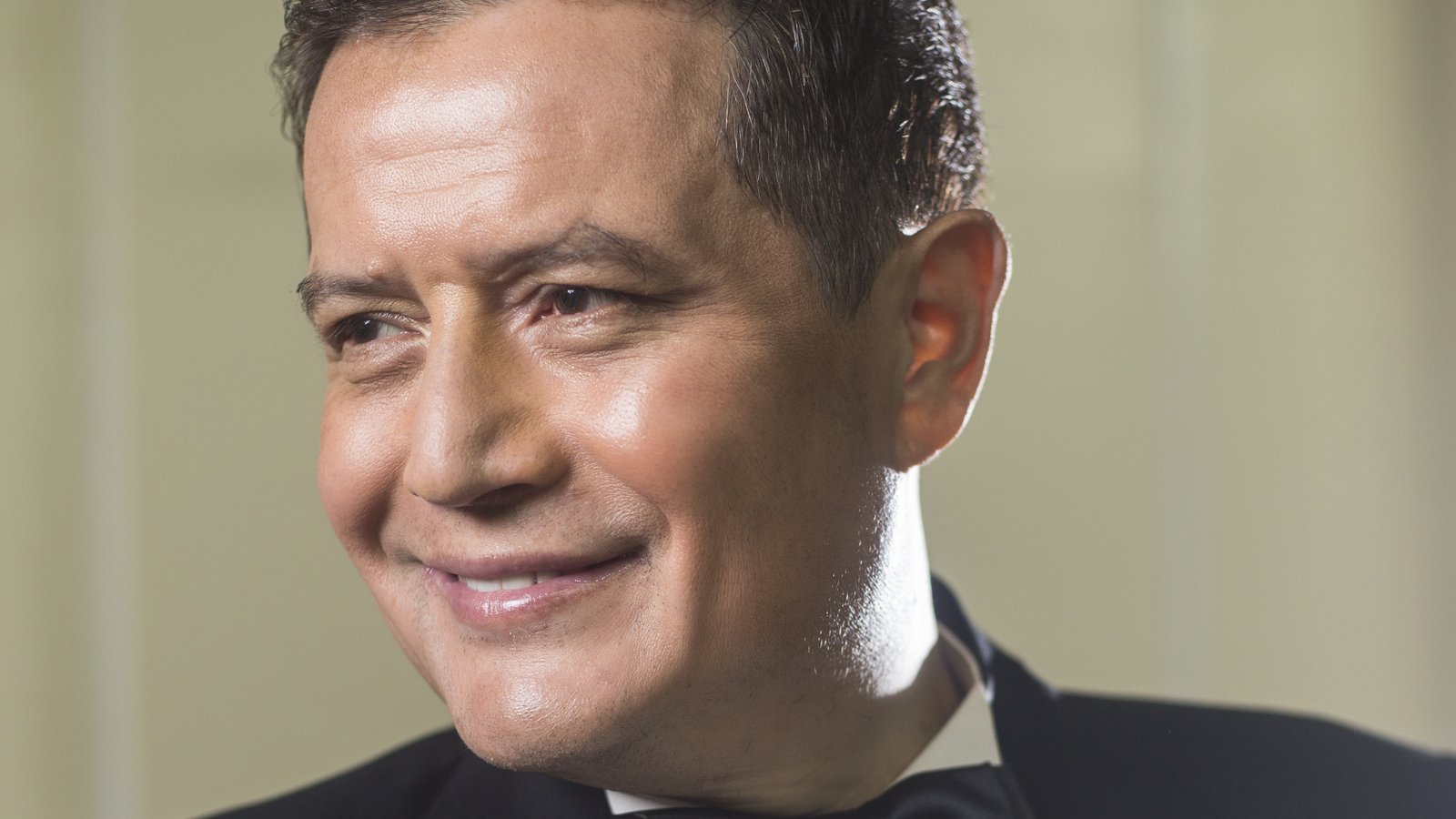 Neil Nongkynrih, founder and conductor of the Shillong Chamber Choir, smiling in a black suit and bow tie