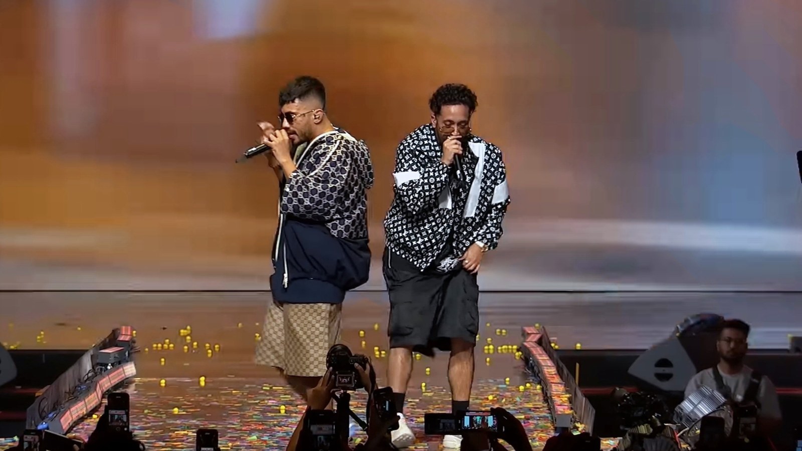 Seedhe Maut's Siddhant Sharma and Abhijay Negi rapping on stage at YouTube Fanfest 2024 in matching monogram jackets