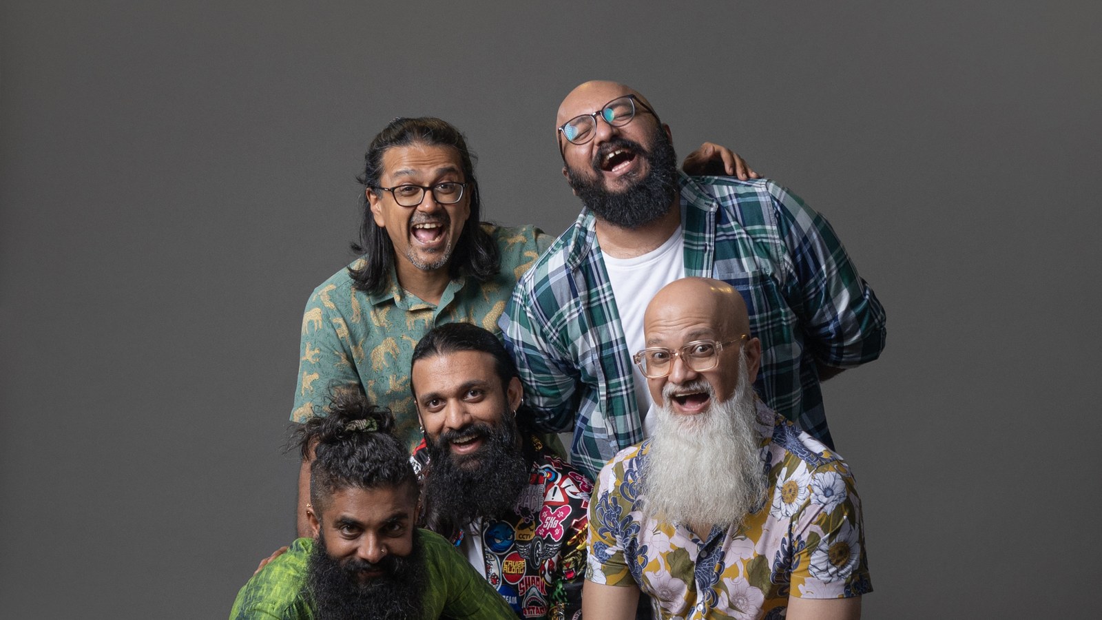 The five members of Bengaluru folk-rock band Swarathma laughing together in a 2024 press photo against a grey backdrop