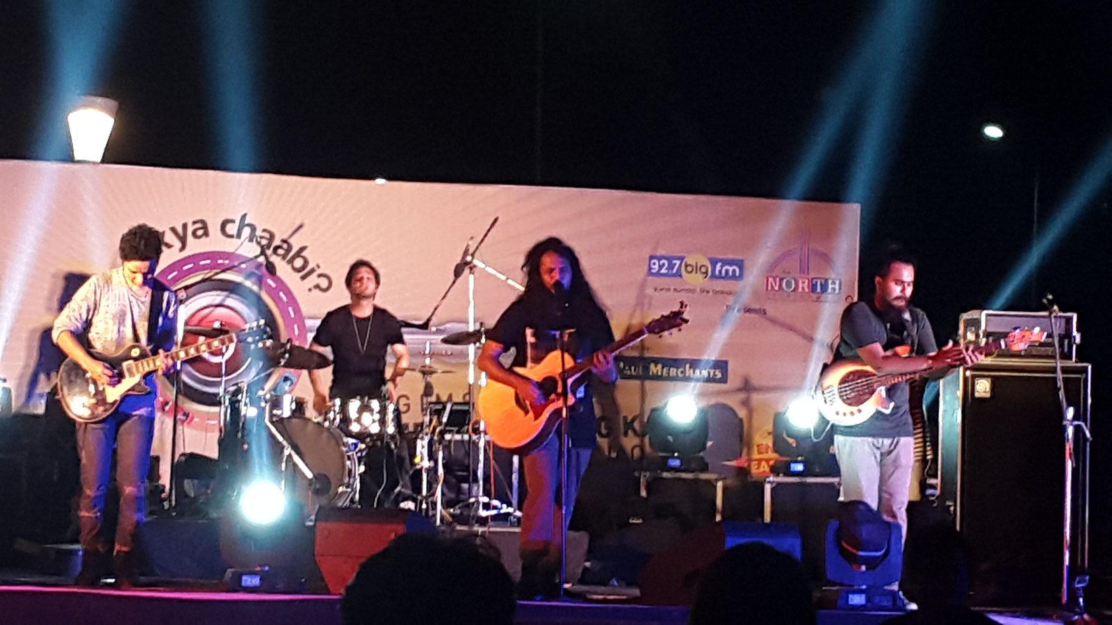 The Local Train performing live on stage in 2016, with guitars and drums under blue lights