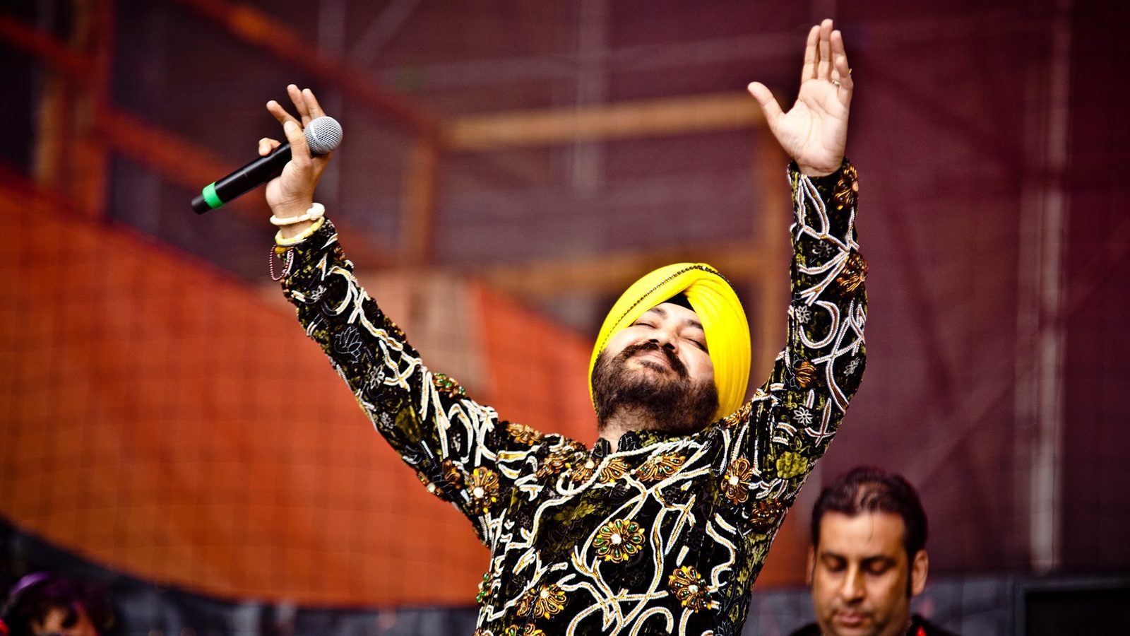 Daler Mehndi performing on stage with his arms raised at You Fest in Madrid in 2015