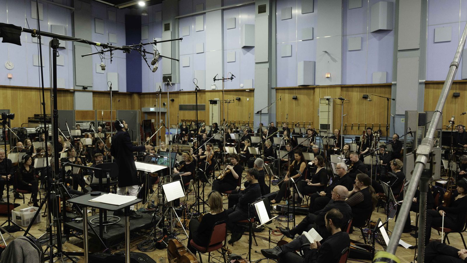 Ricky Kej conducting the Royal Philharmonic Orchestra in the recording room at Abbey Road Studios in London